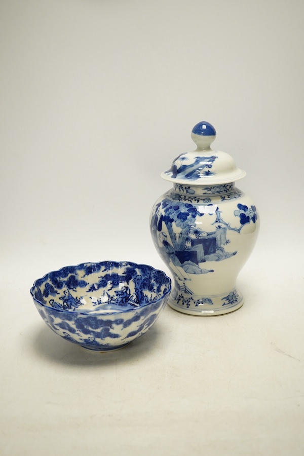 An early 20th century Chinese blue and white porcelain vase and cover decorated with figures in a landscape and a Japanese circular bowl, tallest 23cm. Condition - good